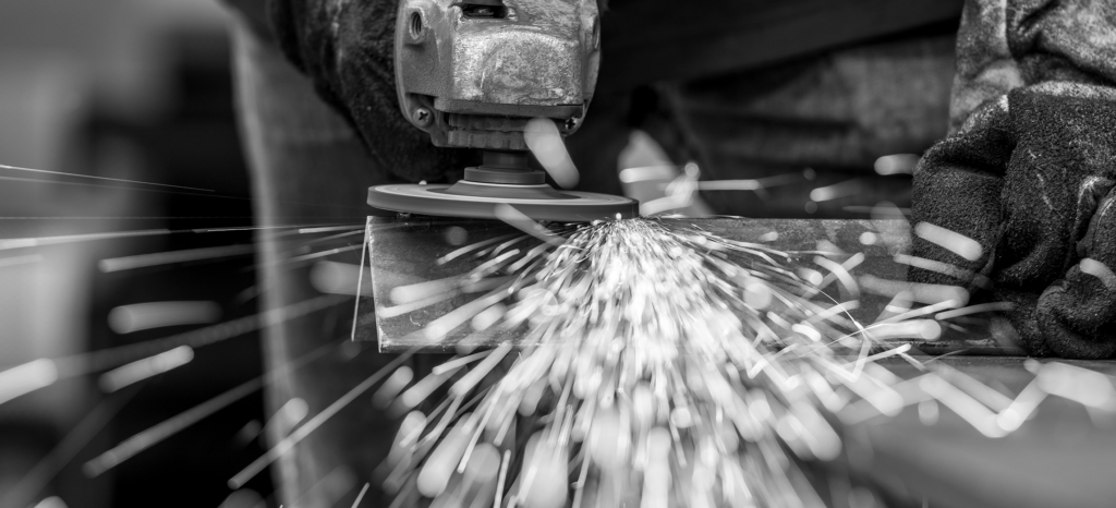 Close up of worker sanding metal object